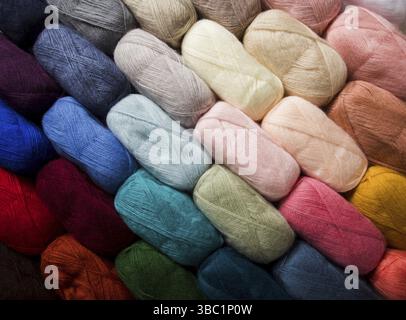 Closeup of multicolored threads that are folded in a row diagonally. Bundles of cotton threads as a background Stock Photo