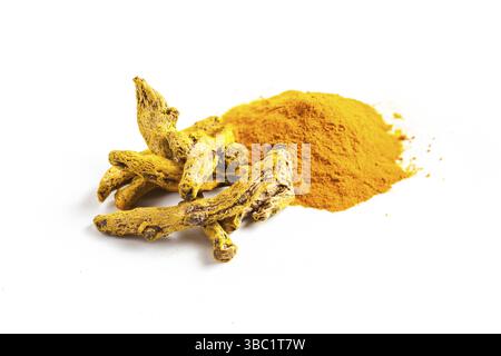 The turmeric spice - powder and dry roots isolated on white Stock Photo