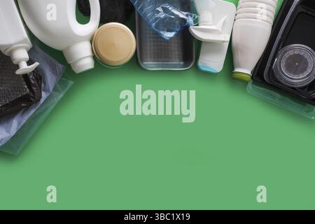 Processing plastic concept. Plastic containers on the green, top view Stock Photo