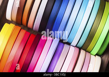 Various colors ribbon bobbins close up Stock Photo