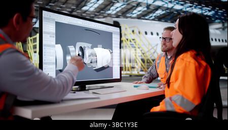 Aircraft Engineer Inspects Jet Engine In Hangar For Maintenance. Stock Photo