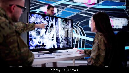 Military Cybersecurity Officer Analyzing Satellite Data At Technology Center Headquarters. Stock Photo