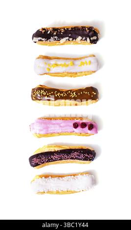 Top view of eclairs with different fillings and designs. Delicious eclairs arranged in a row up and isolated on a white background Stock Photo