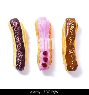 Top view of a set of three eclairs with different fillings and design isolated on a white background Stock Photo