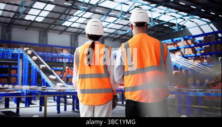Warehouse Workers Strategize Packaging Process In Efficient Modern Distribution Center. Stock Photo