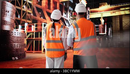 Steel Mill Engineers Discussing Ironwork With Woman In Manufacturing Plant. Possible Professions: Engineer, Welder Stock Photo