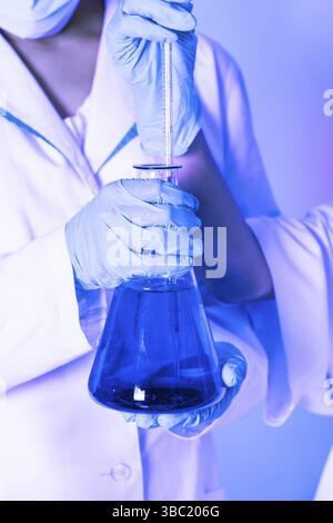 Scientist shows a diffusion in the flask Stock Photo