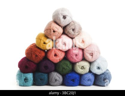 The set of threads stacked on top of each other isolated on white the background. The multicolored threads are folded in the shape of a pyramid Stock Photo