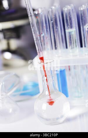 Scientist shows a diffusion in the flask Stock Photo