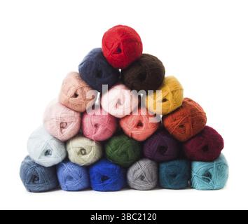 The collection of multicolored threads that are stacked on top of each other. The cotton threads folded in the shape of a triangle isolated on white b Stock Photo