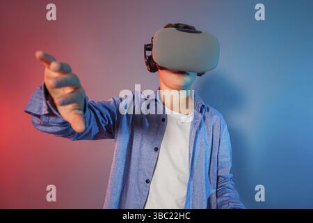 Teenager boy using a gaming gadget for virtual reality. Augmented reality in gaming Stock Photo