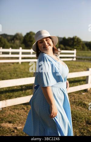 Candid woman in hat at farmland