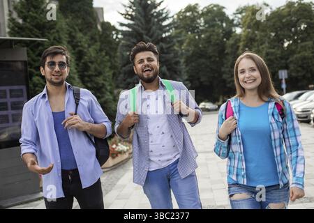 Group of high school students talking and laughing in the street Stock Photo