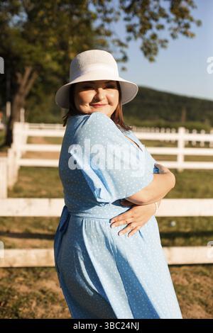 Candid woman in hat at farmland enjoy the summer Stock