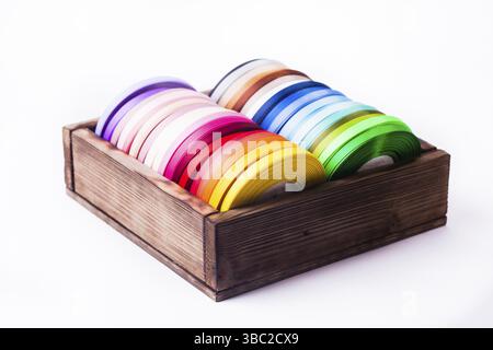Color ribbon bobbins in the vintage box isolated on white Stock Photo