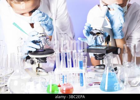 Two scientists in the chemical laboratory are doing experiments Stock Photo