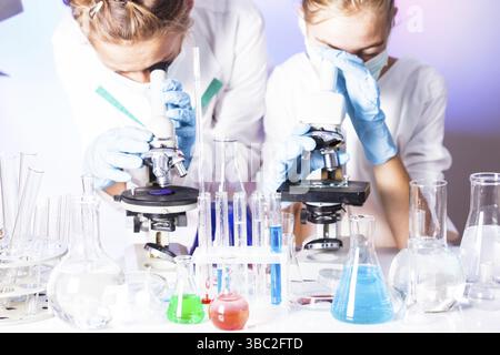 Two scientists in the chemical laboratory are doing experiments Stock Photo