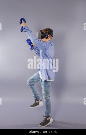 Teenager boy using the virtual reality glasses for virtual reality. Augmented reality in gaming Stock Photo