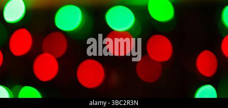 Blurred Abstract Background with Bright Red and Green Bokeh Circles on Dark Background Stock Photo