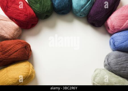 Frame design of color yarn balls on white background Stock Photo