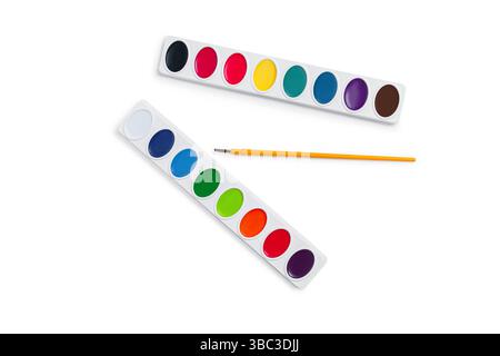 Watercolor paint palettes with vibrant colors, a paintbrush on white background. Ideal for school supplies, art products, creative hobby promotions Stock Photo