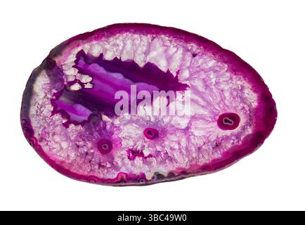 Slice of purple colored agate gem with crystal, amethyst, geode isolated on white background. Closeup cut polished precious stone dyed to pink violet. Stock Photo