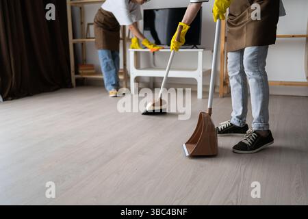 Two female janitors home office clean, cleaning service, professional housekeeping. Close-up Stock Photo