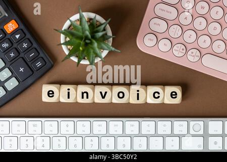E-invoice and digital billing concept, E-invoice symbol on wooden block. Electronic statement management. Online invoice processing, modern tax accoun Stock Photo