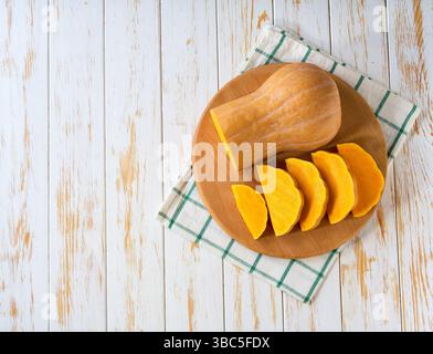 butternut squash, cut into slices on a white table, top view.Top view. Stock Photo