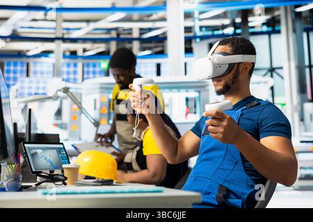 Photovoltaics facility engineer using VR tech to build generators for solar cells to produce renewable energy. Industrial plant employee creates solar panel using virtual reality gear. Stock Photo
