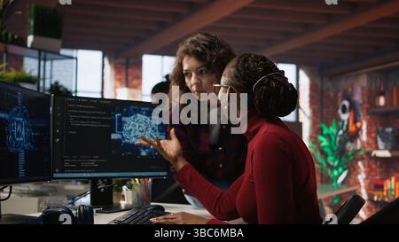 Teamworking engineers coding advanced AI algorithm and machine learning models enhancing automation. Employee talking with coworker in artificial intelligence Silicon Valley workspace, camera A Stock Photo