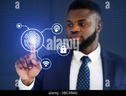 African Businessman Touching Virtual Panel For Fingerprint Scanning, Blue Background Stock Photo