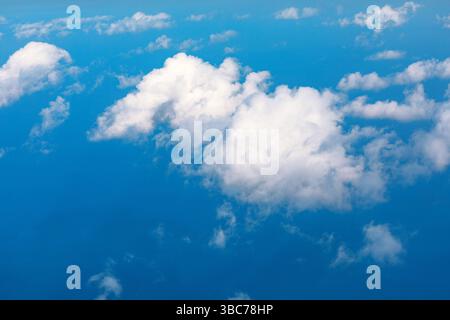Clouds drift across a deep azure sky over the sea. Breathtaking panorama of clouds against a brilliant blue backdrop. Cumulus clouds, like cotton Stock Photo
