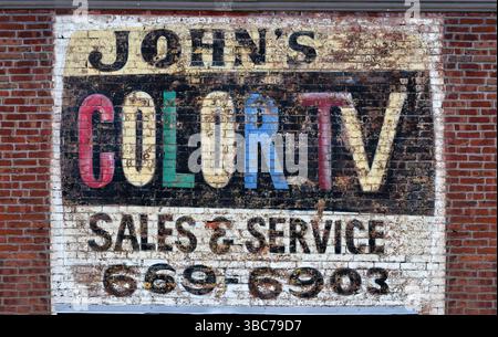 Vintage TV repair ad painted on the brick wall of a building Stock Photo