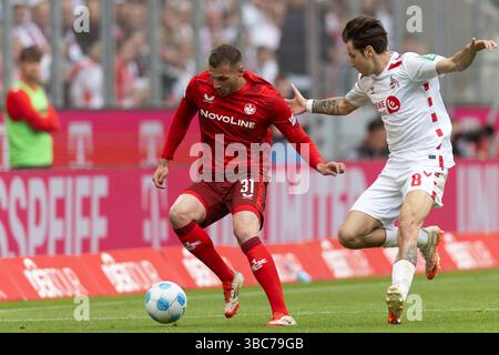 Luca SIRCH (FCK 31, left) on the ball in a duel against Denis HUSEINBASIC (KOE 8, right), action. 2. Bundesliga, 34th matchday, FC Cologne (Koln) (KOE) - 1. FC Kaiserslautern (FCK), final score 4-0, on May 18, 2025, at the RheinEnergieSTADION in Cologne, Germany. #DFL regulations prohibit any use of photographs as image sequences and/or quasi-video # Stock Photo