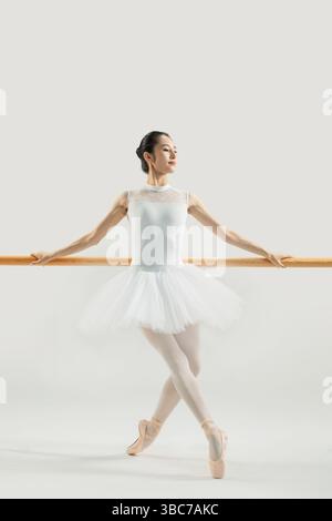 a ballet dancer practicing at the barre​ Stock Photo