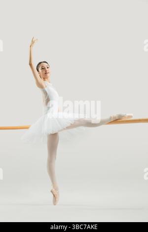 a ballet dancer practicing at the barre​ Stock Photo