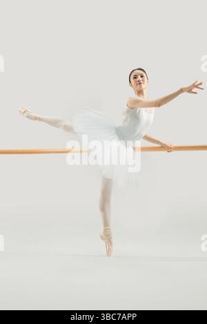 a ballet dancer practicing at the barre​ Stock Photo