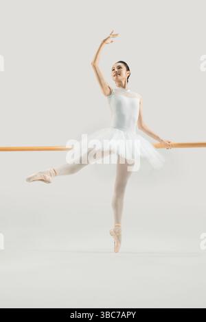 a ballet dancer practicing at the barre​ Stock Photo