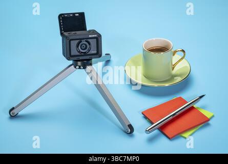 Fort Collins, CO, USA - December 8, 2019: Sony RX0 2 ultra compact robust camera on a mini table tripod with flipped LCD screen and a cup of coffee, v Stock Photo