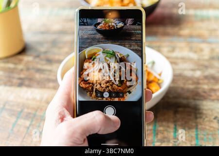 POV shot of taking photo of a meal using the camera app of a smartphone Stock Photo