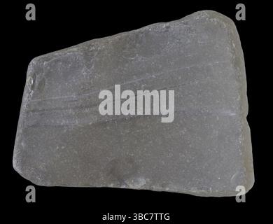 Piece of broken white glass polished, smoothed and frosted naturally by a river, isolated on black Stock Photo