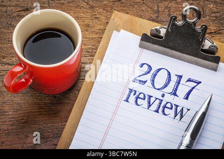 2017 year review on clipboard and coffee against grunge wood desk Stock Photo