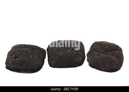 Three small charcoal briquets used for barbeque isolated on white Stock Photo