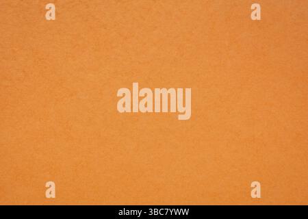 Background and texture of orange handmade Indian paper created from recycled cotton fabric Stock Photo