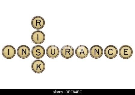 Risk and insurance crossword in old round typewriter keys isolated on white Stock Photo