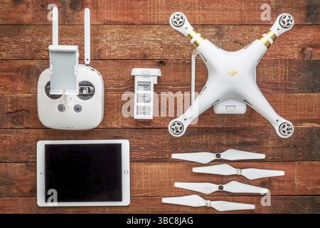 Fort Collins, CO, USA - August 31, 2015: DJI Phantom 3 quadcopter drone with a set of propellers, radio controller, spare battery and iPad - top view Stock Photo