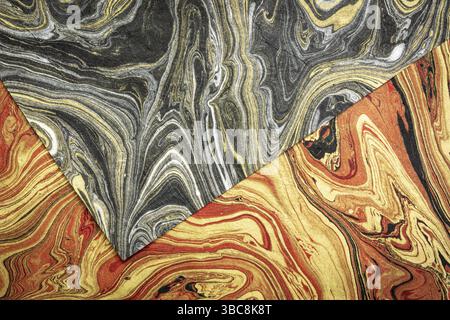 Sheets of red, black, silver and gold Nepalese lokta paper Inspired from the grain of texture in granite stone Stock Photo