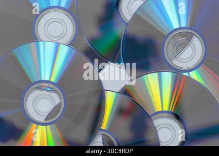 Six DVD discs with light reflection and refraction effect. Stock Photo