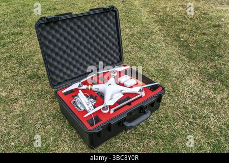 Fort Collins, CO, USA - March 12 2016: DJI Phantom 3 quadcopter drone with a set of propellers, radio controller, iPad tablet and spare batteries in a Stock Photo
